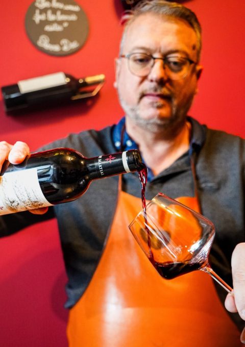 Didier verse un vin rouge dans un verre